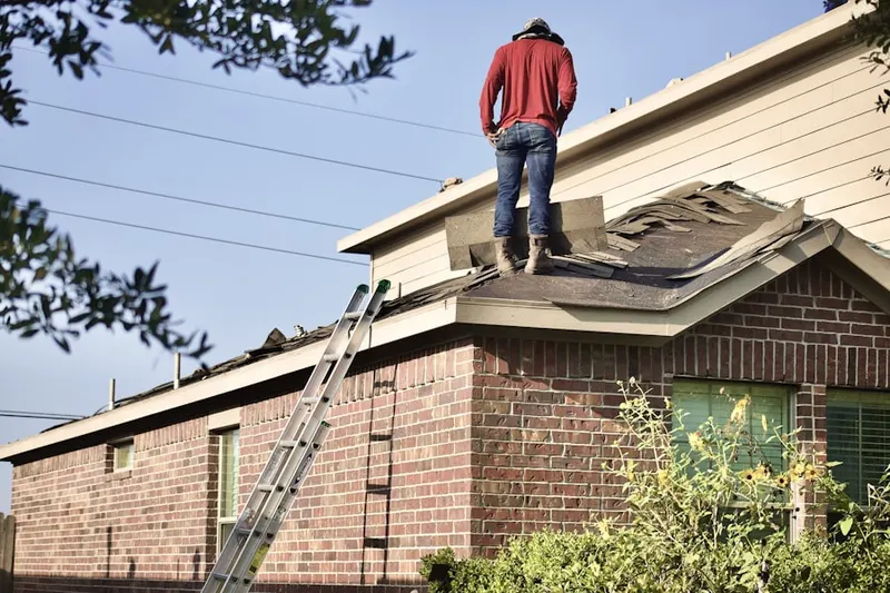 Professional roofer working on a residential roof in Catalina Villas